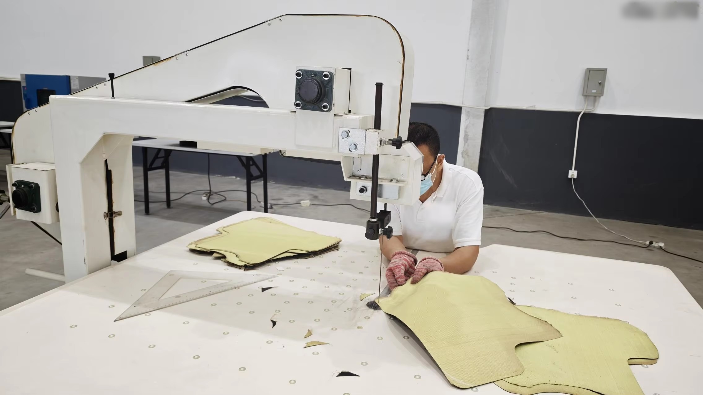 Operator cutting protective panels at the rotary machine