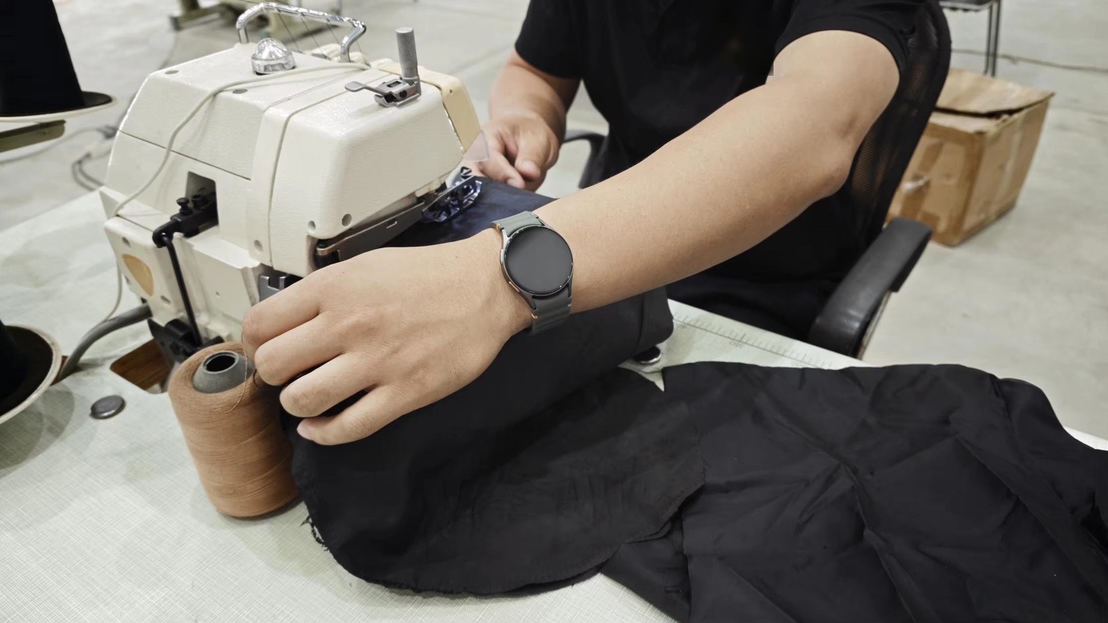 Operator stitching panels on an industrial sewing machine